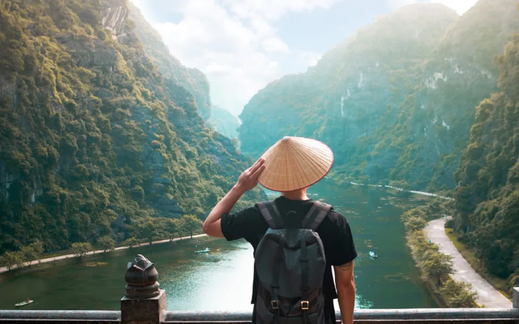 man visiting vietnam with traditional hat